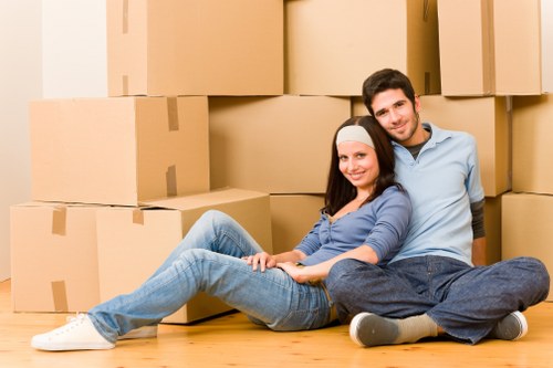 Professional movers handling bulky items on a residential street