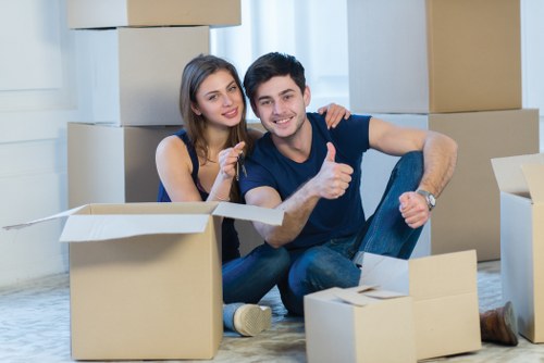 Staff organising boxes and labelled items for a commercial relocation