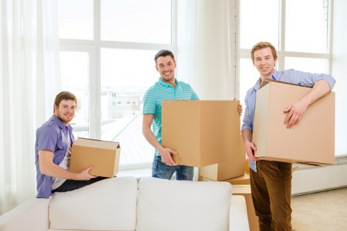 Trained movers handling furniture safely in a property